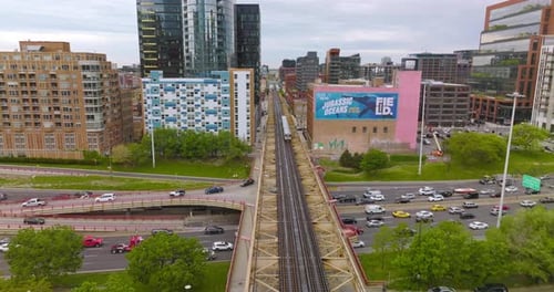 Following the skyway for subway train. Cars going by the road under the train railways.
