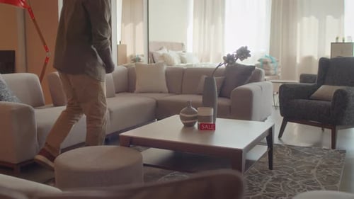 Customer Checking Size of Coffee Table with Tape Measure