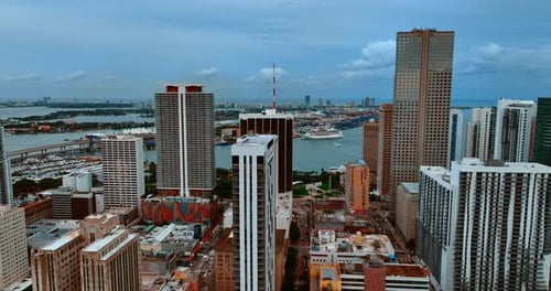 Drone footage among the high-rise buildings and approaching the waterscape. View on Miami, Florida