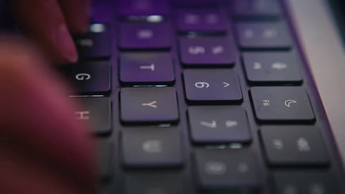 Fingers Typing on a Modern Laptop Keyboard