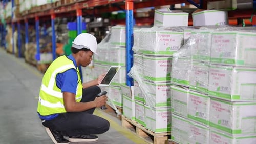 Worker Doing Inventory in Warehouse. Dispatcher in uniform making inventory in storehouse. supply ch