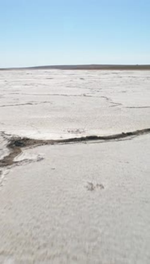 Salt Lake with Deposits of White Salt and Cracks Aerial View Vertical Video