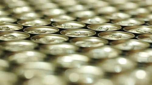 Golden can tops in a beverage factory