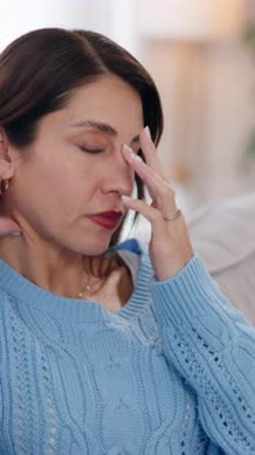 Woman Massaging Temples to Relieve Headache