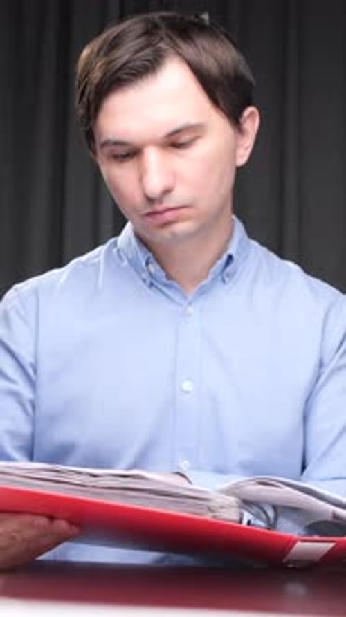 Vertical Video Office Worker Searching Documents in a Folder at Night