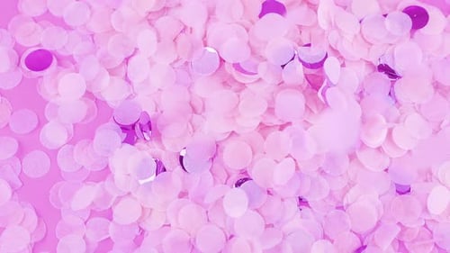 Falling confetti on a pink background. Slow motion.