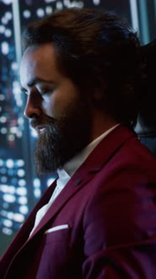 Adult Man in Maroon Suit Smiles at Camera