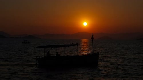 Boat Sailing on Ocean at Beautiful Sunset
