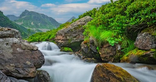 Timelapse Landscape of a Moving Mountain River and Clouds