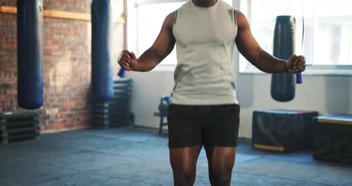 Man, fitness and body skipping rope in cardio workout, exercise or training at indoor gym