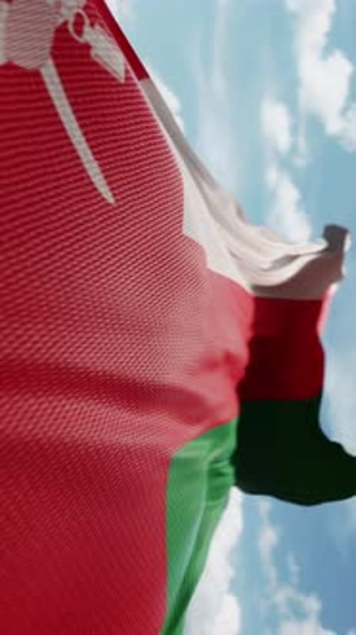 Oman Flag Waving Against Blue Sky