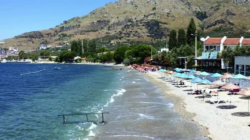 Drone shot. Beachside with blue umbrellas. Sea waves are hitting the shore. 4K
Marmara island. Turke