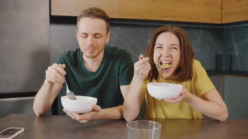 Couple Enjoys Cereal Together in Modern Kitchen