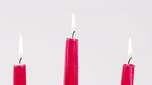 Burning Red Candles on White Background