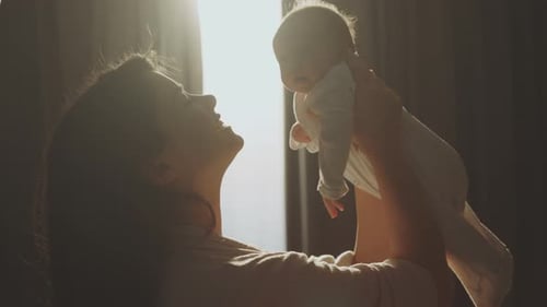Mother Holds Baby Up to the Light