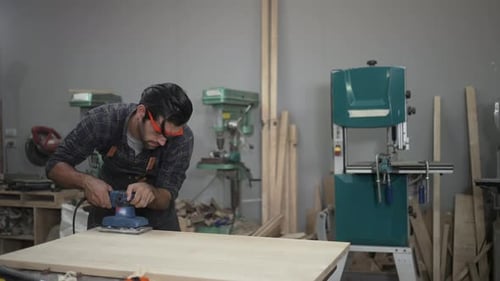 Carpenter is working at workshop.