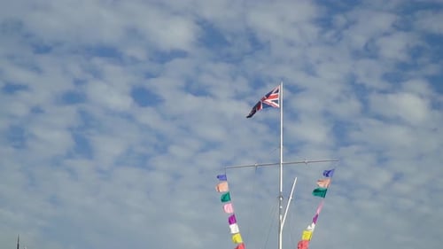 Union Jack Flag Waves in Blue Sky