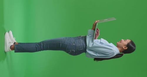 Full Body Asian Business Woman Using Laptop Computer On Green Screen Background In The Studio