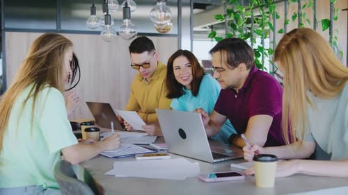 In a Stylish Plantfilled Workspace a Diverse Team of Skilled Professionals Collaborates Efficiently