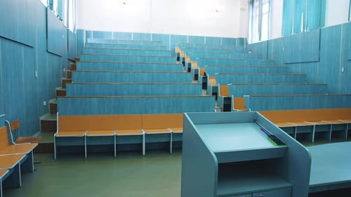 Auditorium For Lectures At University. Empty auditorium with wooden desks and chairs
