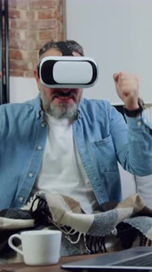 Man with VR Goggles Cheering Indoors