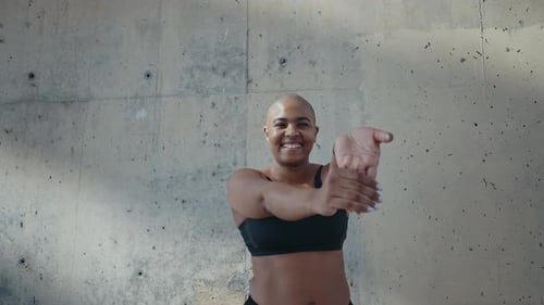 Smiling Woman Stretching her Arms Outdoors