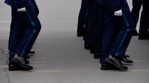 Closeup of Uniformed Personnel Marching in Precise Formation During a Ceremonial Parade with