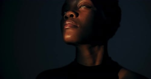 Woman Posing in the Darkly Lit Room