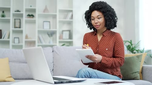 Woman Working from Home Taking Notes
