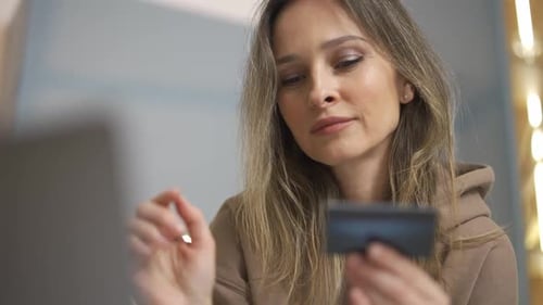 Woman shops online with Credit Card