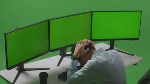 Asian Man Having Headache While Working With Mock Up Multiple Computer Monitor In Green Screen