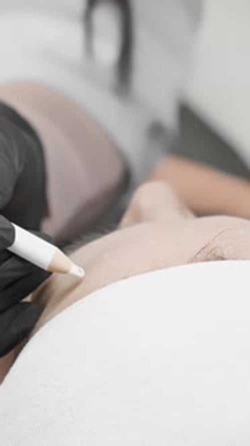 Cosmetic Technician Prepping Brows with Pencil