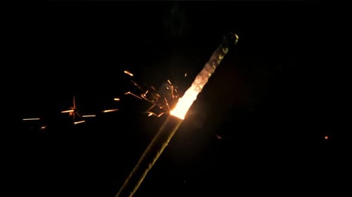 Sparkler Burns and Emits Glowing Sparks at Night