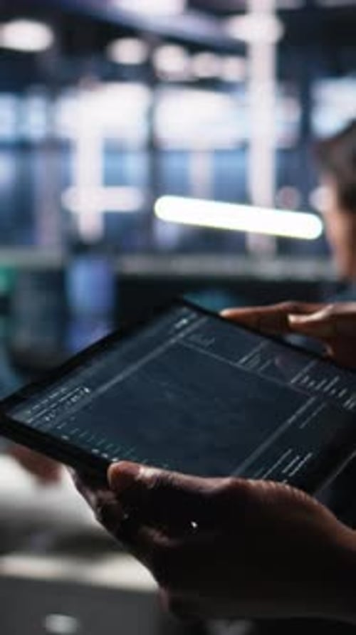 Vertical Video Close Up of Data Center Programmer Using Tablet Writing Code