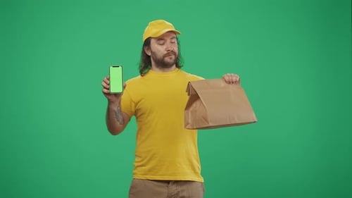 Delivery Man in Uniform Holding Paper Bag and Smartphone Advertising Area Workspace Mockup