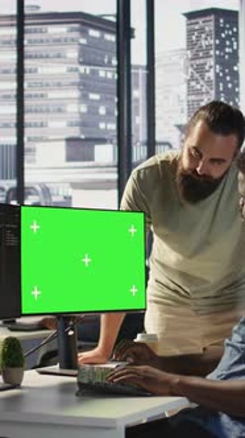 Vertical Video System Administrator Does Software Debugging on Green Screen PC with Colleague