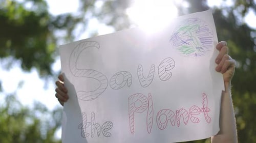 Activist Holding Save the Planet Sign