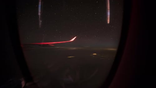 Night Sky and City Lights from Airplane Window Over Shanghai