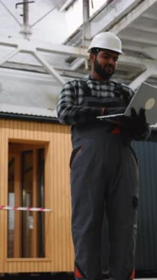 Indian Engineer Reviewing Prefab House Construction Plans