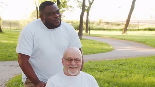 AfricanAmerican Caregiver and Old Man Professional Nurse and Patient in a Nursing Home Assistance