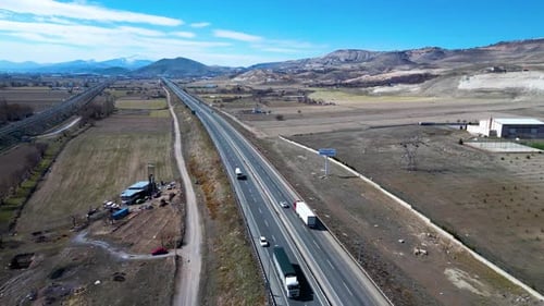 A breathtaking aerial view of a massive intersection, showcasing the dynamic flow of traffic and int