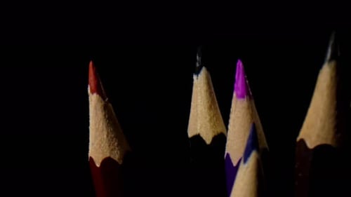 Vibrant Sharpened Colored Pencils Against Black Backdrop