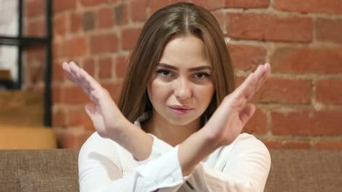 Woman Saying No with Arms in Studio
