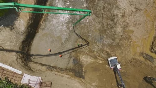 Aerial View Laying Foundations Pouring First Concrete and Equipment in Motion