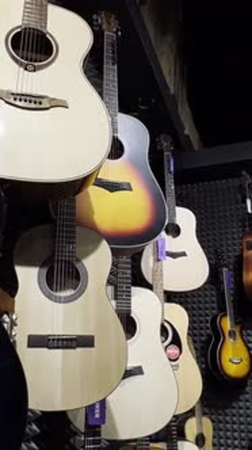 Acoustic Guitars in a Musical Instrument Store Beautiful Multicolored Guitars Vertical Video