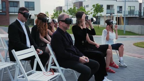 Adults Experiencing Virtual Reality Technology at Outdoor Event