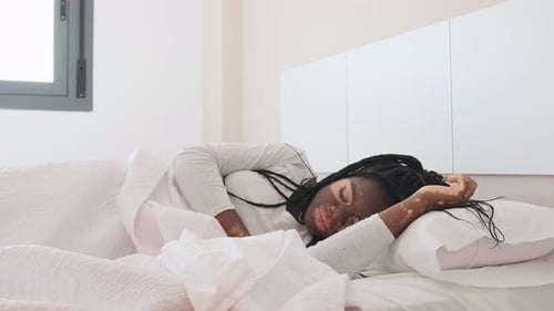Woman Waking Up and Stretching in Bed