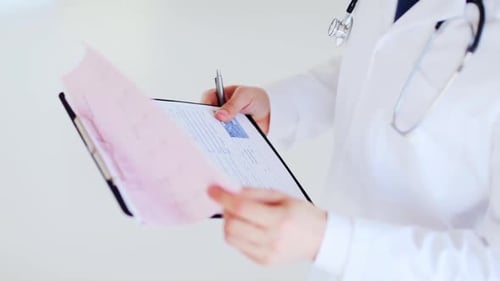 Closeup of Male Doctor Making a Prescription Beat