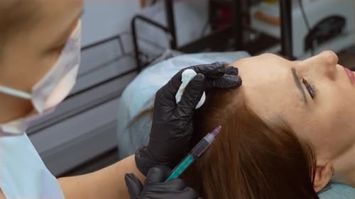 Woman Receives Scalp Treatment at Medical Clinic