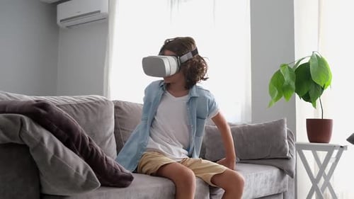 Child Using VR Headset on Couch